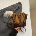 Minimalist bucket bag in dark brown contrast leather with woven handle and drawstring - Brown