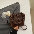Minimalist dark brown bucket bag featuring woven handle and mixed texture design - Coffee