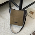 Close-up of olive green bucket bag with leather patchwork and NO FILTER label detail - Brown