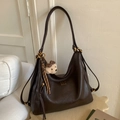 Detail of dark brown Hobo bag featuring gold hardware and plush bear charm decoration - Coffee With Pendant