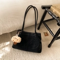 Detail of black suede tote bag with contrast stitching and a small monster plush pendant - With Pendant / Black
