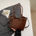 Detail of vintage brown leather bucket bag with embossed logo and unique abacus charm - Brown with Pendant