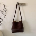 Detail der dunkelbraunen Wildleder-Beuteltasche mit verstellbarem Lederriemen und Boden - Braun