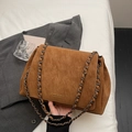 Detailansicht der karamellfarbenen Ledertasche mit Vintage-Kette und Markenlogo - Braun