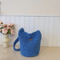 Bright blue plush bucket bag with fuzzy texture and a brown leather logo patch - Blue Without Charm