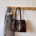 Dark brown leather tote bag with silver buckle and shoulder straps on a wooden hook - Coffee without Pendant