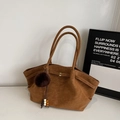 Detail view of brown faux suede tote bag with decorative fur pompom and beaded charm - With Pendant / Brown