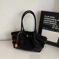 Close-up of black suede tote bag with brown pompom and wooden bead tassel detail - With Pendant / Black