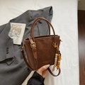 Detail of vintage brown bucket bag with gold hardware and colorful wooden bead charms - Brown with Pendant