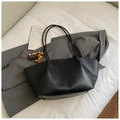 Detail of black wax leather tote bag with wooden bead tassel and long shoulder strap - Black With Pendant