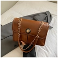 Detail of caramel brown PU leather shoulder bag with golden chain and twist lock - Tan