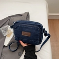Detail of dark blue denim crossbody bag with brown leather label and multi-zipper pockets - Dark Blue