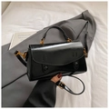 Detail of elegant black matte handbag with vintage gold hardware and shoulder strap - Black