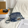 Retro washed denim crossbody bag with vintage leather patch on a soft white background - Light Blue