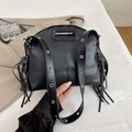 Minimalist black leather underarm bag with metal grommet strap and tassel detail - Black