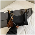 Detail of black suede shoulder bag with golden hardware and ethnic tassel pendant - Black With Pendant