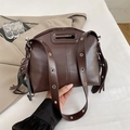 Dark brown retro style matte leather handbag with decorative tassels and eyelet strap - Brown