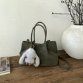 Detail of vintage green matte bucket bag with a cute white bunny plush keychain charm - Green with Pendant
