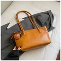 Brown leather tote bag with pebble texture and cute plush monster charm accessory - Brown with Pendant