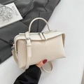 Detail der minimalistischen cremefarbenen Boston Bag aus Leder mit Silber-Zippern - Gebrochenes Weiß
