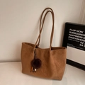 Detail of camel tote bag featuring matte leather texture and colorful beaded tassel charm - With Pendant / Brown