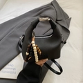 Black textured leather handbag with silver hardware and beaded tassel decoration - Black With Pendant