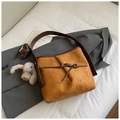 Mode-Eimertasche in Karamellbraun mit Faltenstruktur, Schleife und weißem Kaninchenanhänger - Braun mit Anhänger
