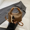 Chic tan canvas crescent handbag with metal buckle handle and decorative bead charm - Brown with Pendant