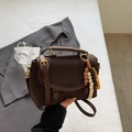 Detail of dark brown vintage leather handbag with litchi texture and beaded charm - Coffee With Charms