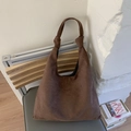 Detail showing high-capacity suede hobo bag with unique knotted handle design and soft texture - Brown