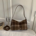 Detailaufnahme der braunen Karo-Tasche mit Wolltextur und Leder-Fashion-Label - Braun