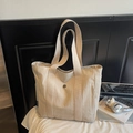 Detailed view of beige waterproof nylon tote bag with CHUANGMI brand tag and metal logo - Off White