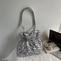 Detailed view of silver quilted drawstring tote bag with puffer texture and thin shoulder straps - Silver