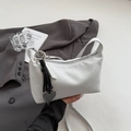 Détail du sac bandoulière en daim gris avec anneau argenté et pendentif cœur noir - Blanc Cassé