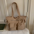 Detail view of the khaki corduroy tote bag showing multiple functional front pockets - Khaki