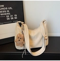 Off-white leather tote bag with wide shoulder strap and brown puppy plush charm detail - With Charm / White