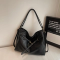 Large black vintage tote bag with metal eyelet straps and gold-tone hardware detail - Black