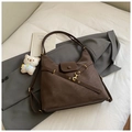 Detail of dark brown leather tote bag with gold buckle and white bear plush keychain - Coffee With Pendant