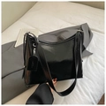 Macro view of high-gloss black oil wax leather texture on this minimalist tote bag - Black