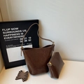 Detail view of dark brown vintage PU leather bucket bag with matching zipper pouch and strap - Brown