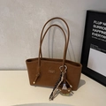 Close-up of brown frosted leather tote bag with cute bear charm and tassel detail - Brown with Pendant