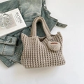 Beige chunky knit handbag with handmade heart charm on denim fabric background - Off White