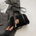 Detail of black suede bowling bag with creative baseball charm and silver hardware on a blazer - With Pendant / Black
