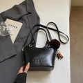Detail of black wrinkled leather bucket bag with tassels and fur ball accessory - With Pendant / Black