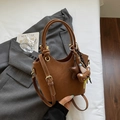 Brown frosted bucket bag detail with white decorative stitching and cute teddy bear charm - Brown with Pendant