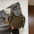 Close-up of olive green bucket bag featuring premium suede texture and golden hardware details - Green with Charm