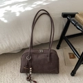 Detail of dark brown matte suede shoulder bag with dual zippers and ethnic style charm - With Pendant / Brown