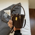 Retro dark brown bucket bag with gold twist lock, plush bear charm and shoulder strap - Coffee With Charms