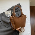 Brown vintage leather bucket bag with circular handles and gold buckle accents - Brown No Pendant