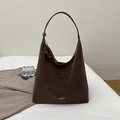 Close-up of deep brown hobo bag showing leather texture and printed logo on the bottom - Brown